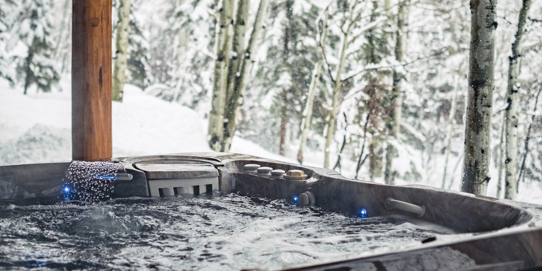 Outdoor Caldera Spas hot tub set in a snowy mountain landscape